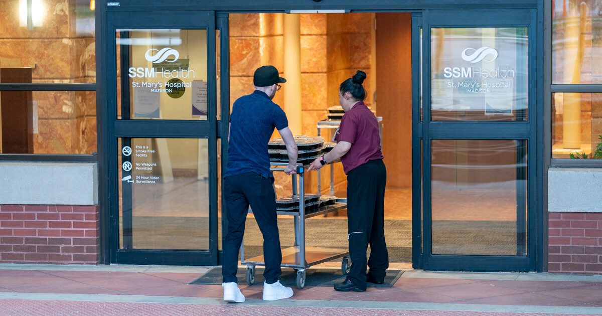 SSMHealth employees head back into the Madison hospital to distribute free meals to employees.