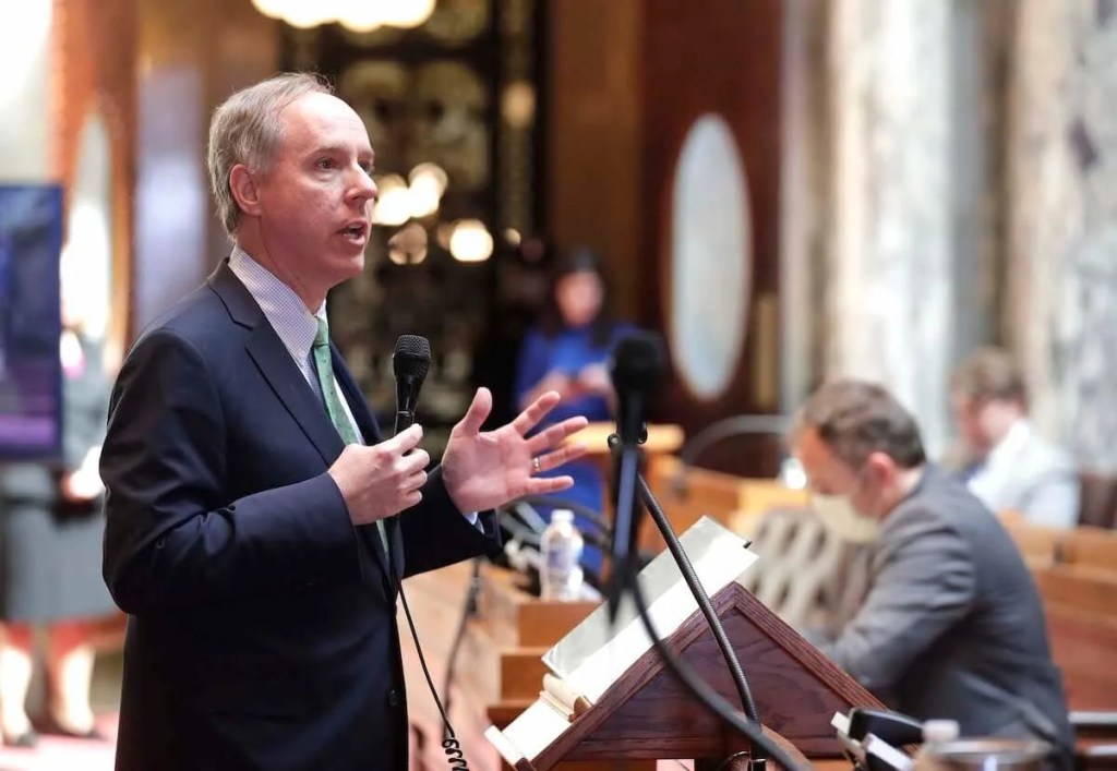 Speaker Vos Demands In-Person Assembly Sessions, Despite Putting Members’ Health at Risk
