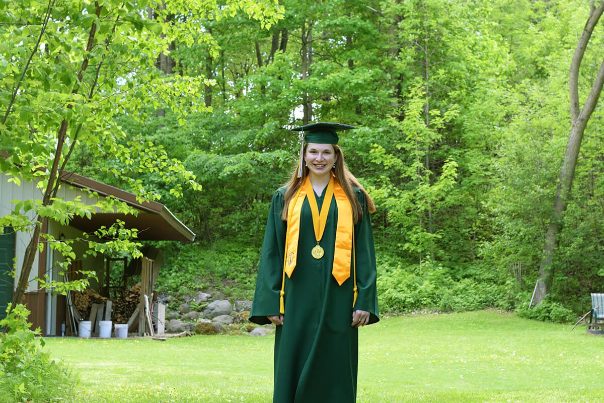 Caps and Gowns and a Great Big Screen as a Wisconsin Class Graduates at a Drive-In