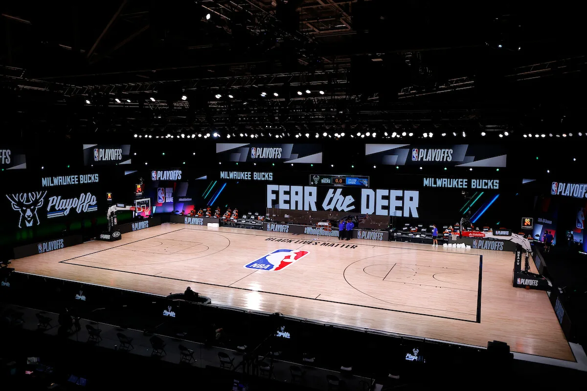 Referees huddle on an empty court at game time of a scheduled game between the Milwaukee Bucks and the Orlando Magic for Game Five of the Eastern Conference First Round during the 2020 NBA Playoffs at AdventHealth Arena at ESPN Wide World Of Sports Complex on August 26, 2020 in Lake Buena Vista, Florida. (Photo by Kevin C. Cox/Getty Images)