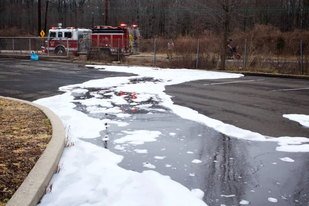 Bensalem, Pennsylvania / USA - February 7, 2019: Firefighting foam remains on the ground surface following a tanker truck accident.