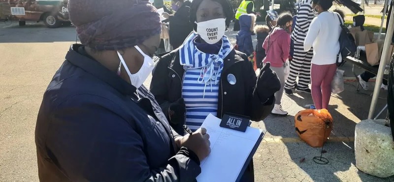 Maletha Jones (holding clipboard), Field Operations Manager for Black Leaders Organizing Communities (BLOC) takes part in an event the week before the Nov. 3, 2020 election.