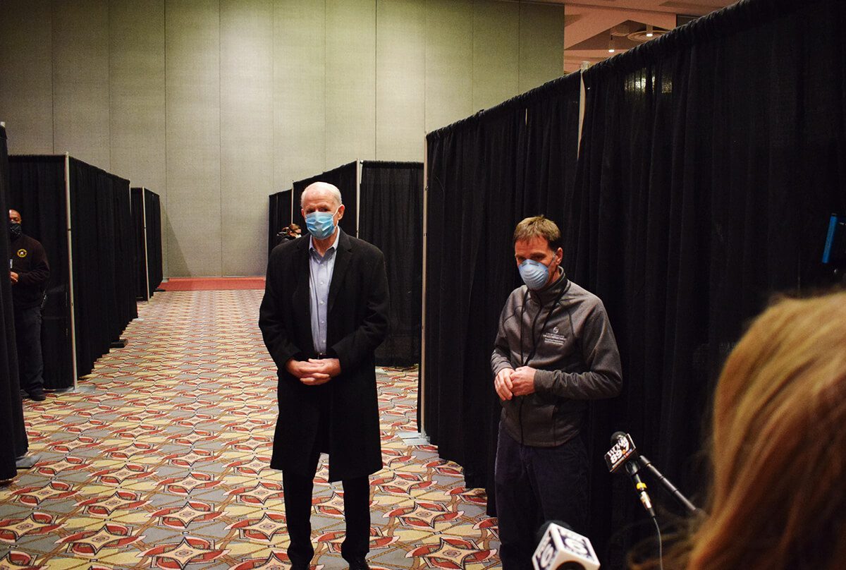 Milwaukee Mayor Tom Barrett, left, and Dr. Nick Tomaro of the Milwaukee Health Department stand outside a COVID-19 vaccine station set up in the Wisconsin Center in downtown Milwaukee. 