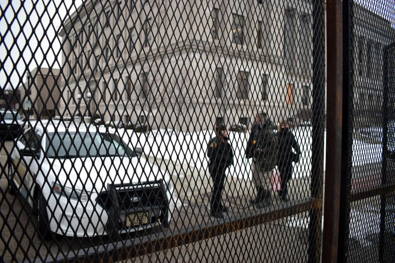 Sheriff's deputies stand outside the fenced-off Kenosha County Courthouse Monday afternoon.