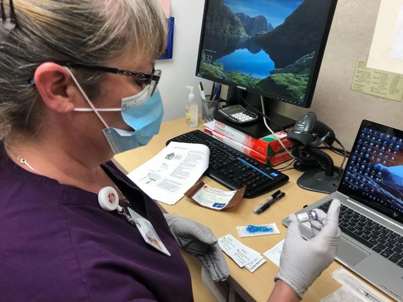 Dana Hanson, assistant operations manager at Marshfield Medical Center-Eau Claire, holds a vial of COVID-19 vaccine in preparation for giving out shots to fellow healthcare workers in the first group of recipients. (Photo courtesy of Marshfield Clinic.)