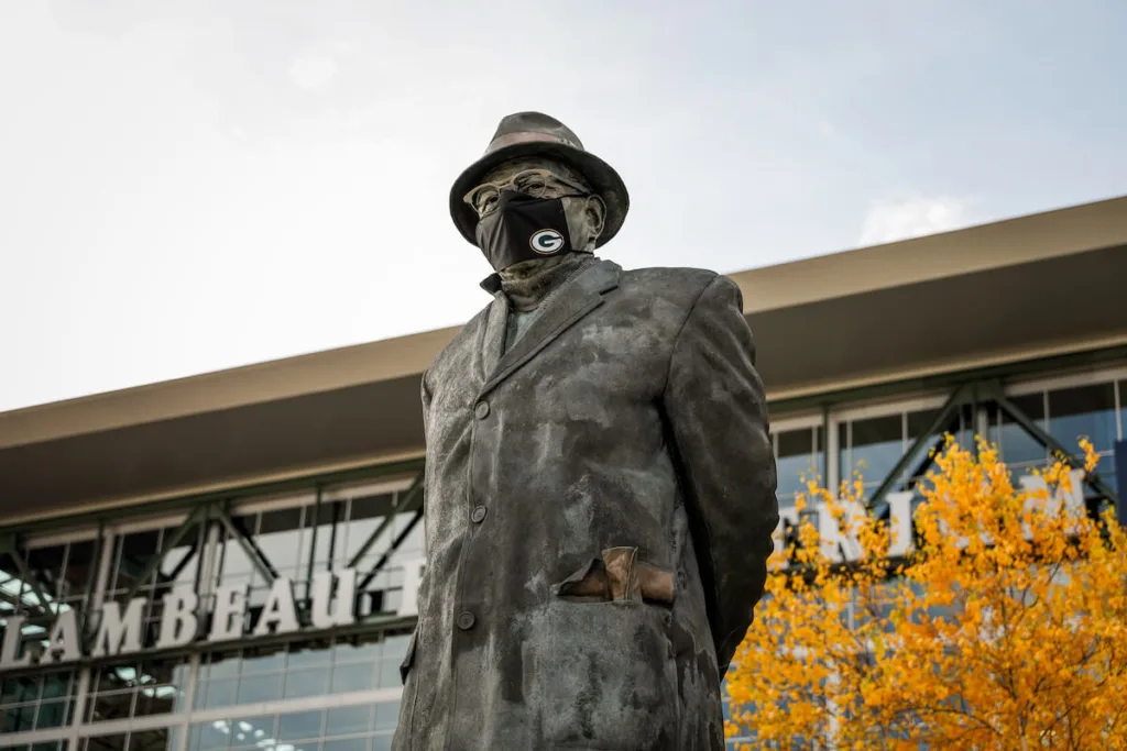 In a sign of the times, the statue of legendary Green Bay Packers coach Vince Lombardi has been masked up since early in the coronavirus pandemic.