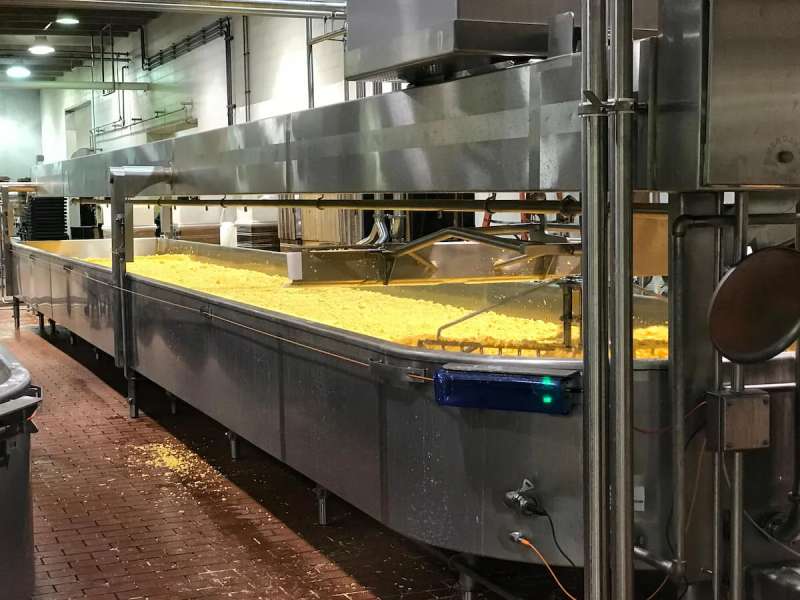 Cheese curds being made at the Wisconsin Dairy State Cheese Company in Rudolph. (Image via Shutterstock)