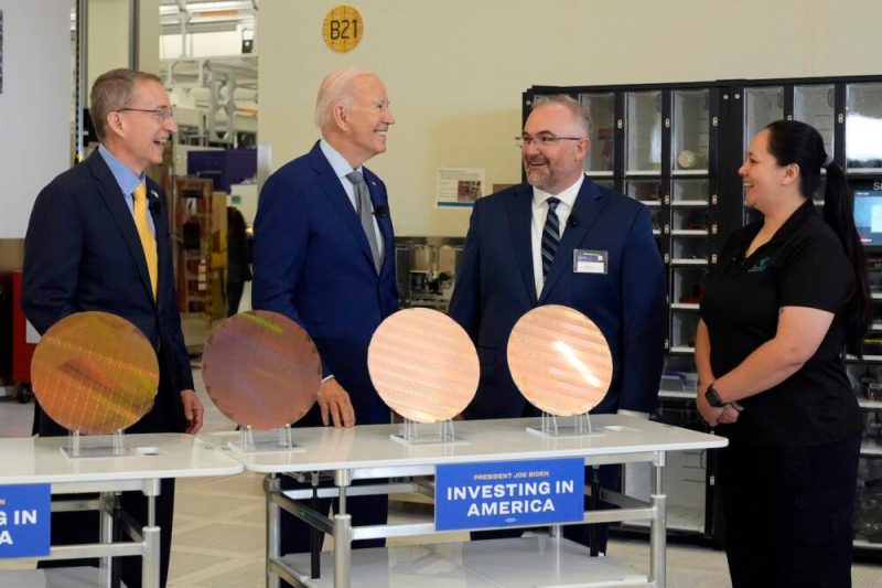 President Joe Biden listens to Intel CEO Pat Gelsinger, left, as Intel factory manager Hugh Green and Intel manufacturing technician Michelle Blackwell listen, during a tour of the Intel Ocotillo Campus, in Chandler, Ariz., Wednesday March 20, 2024. (AP Photo/Jacquelyn Martin)