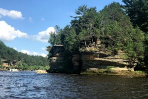 A rock formation and lush trees at Wisconsin Dells.