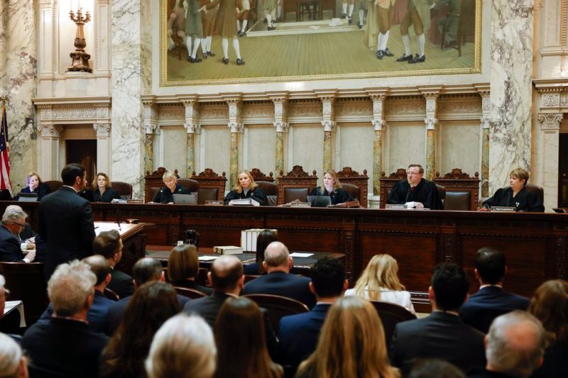 FILE - The Wisconsin Supreme Court listens to arguments from Wisconsin Assistant Attorney General Anthony D. Russomanno, representing Gov. Tony Evers, during a redistricting hearing at the state Capitol, Nov. 21, 2023, in Madison, Wis. The Wisconsin Supreme Court on Wednesday, Dec. 13, declined to hear a lawsuit brought by Democrats seeking to end the state's taxpayer-funded private school voucher program. (Ruthie Hauge/The Capital Times via AP, Pool, File)