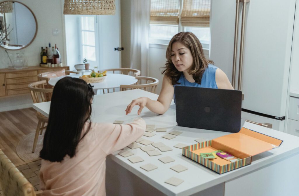 Mom talking to her daughter while working.