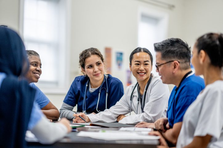 Nurses and Doctor sit around a table