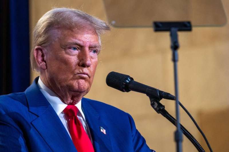 Trump speaking to microphone