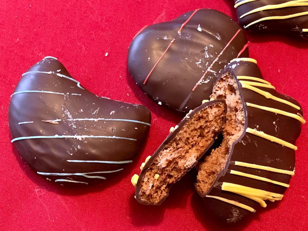 Bites of cakelike gingerbread are drenched in chocolate after being cut into star, heart and moon shapes at Clasen European Bakery, Middleton.
