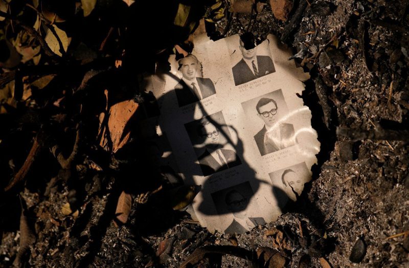 FILE - A partially burned yearbook is seen on the ground in the aftermath of the Palisades Fire in the Pacific Palisades neighborhood of Los Angeles, Monday, Jan. 13, 2025. (AP Photo/John Locher, File).
