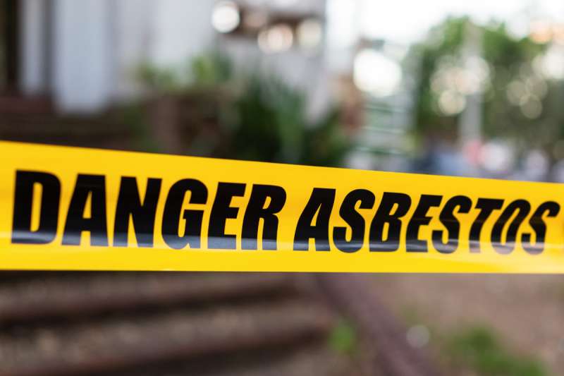 "Danger Asbestos" yellow warning tape barrier
