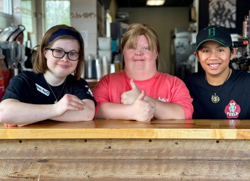 Smiling employees at Inclusion Coffee