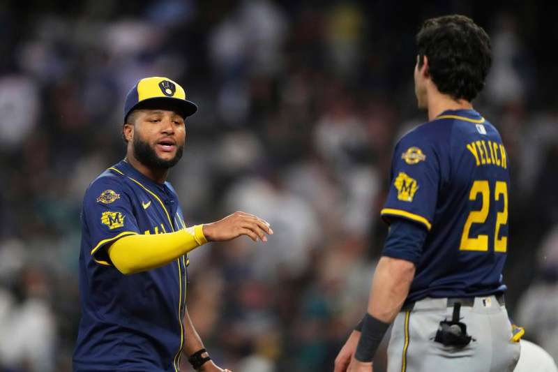two baseball players discuss ball on the field