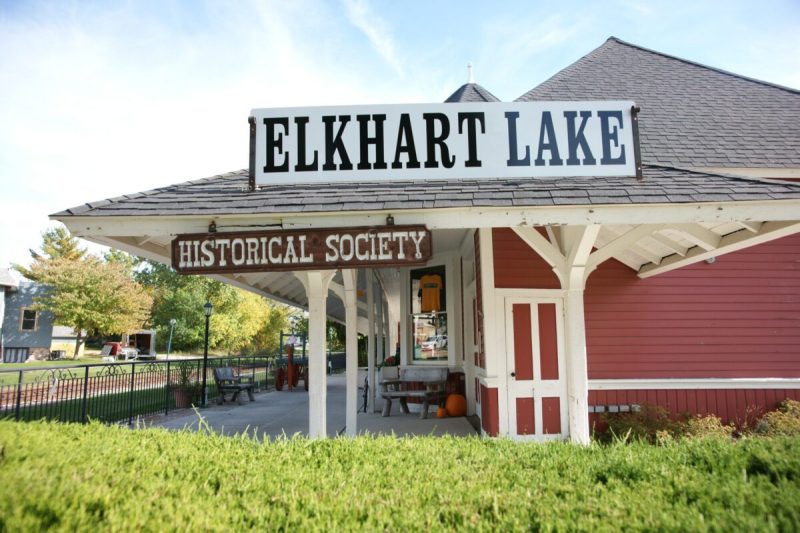 a red house with a sign that reads elkhart lake