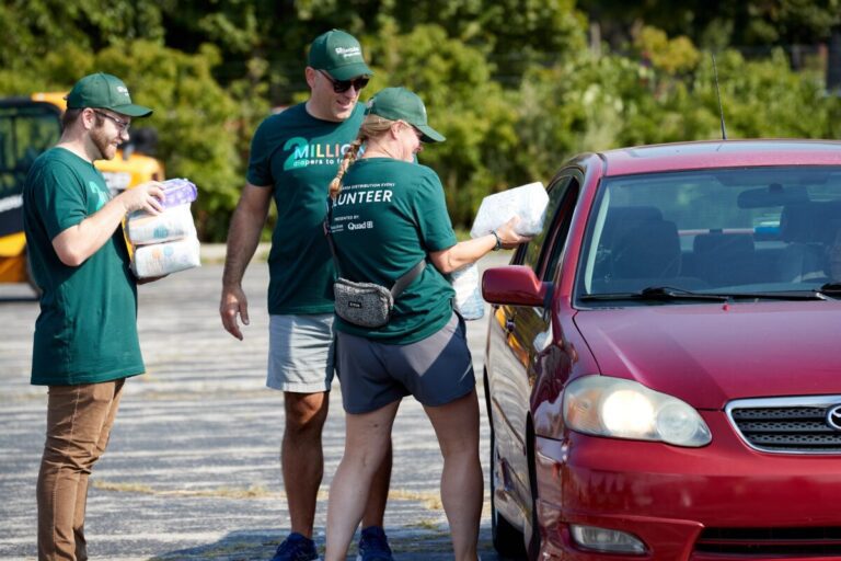 Volunteers deliver diaper donations to community members.