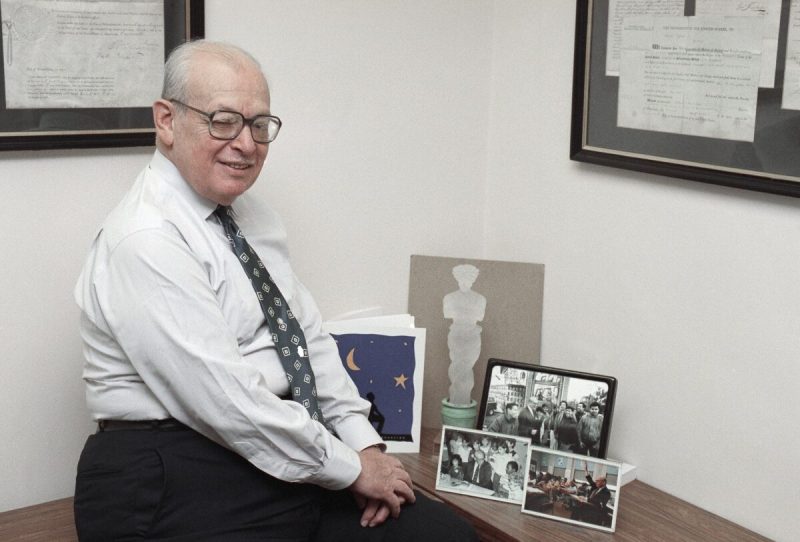 Eugene Lang, founder of the “I Have a Dream Foundation,” poses in his New York office with photos of students his foundation has helped send to college, June 22, 1991. It has been 10 years since Lang adopted a sixth grade class and promised to pay their college tuition if they stayed in school. Lang will honor the first two students to receive baccalaureate degrees at a reunion.
