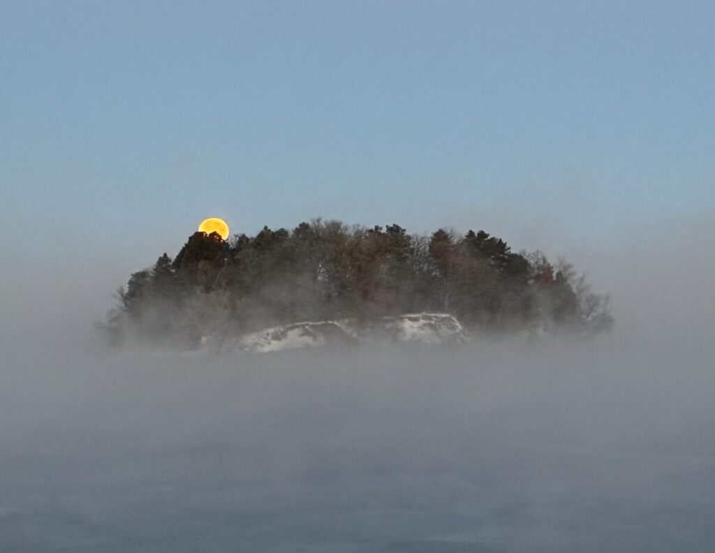 Cold Moon setting over Lake Wissota. Wisconsin view.