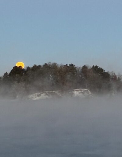 Cold Moon setting over Lake Wissota. Wisconsin view.