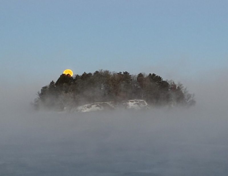 Cold Moon setting over Lake Wissota. Wisconsin view.