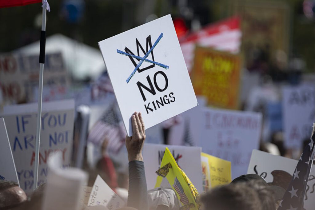No Kings protest sign, No Kings protest in background