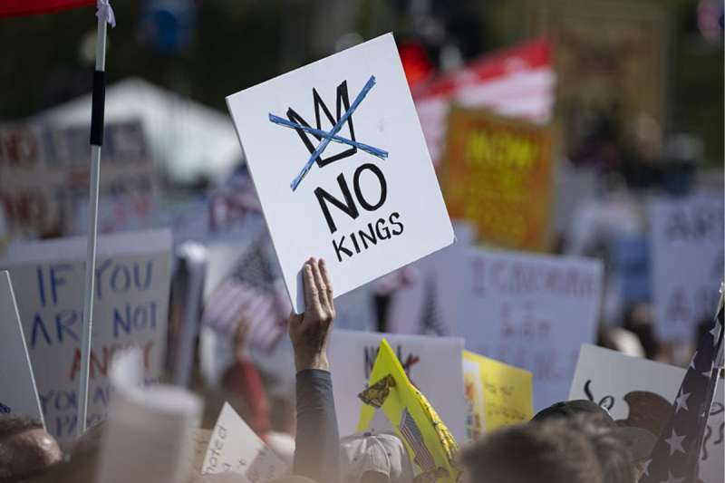 No Kings protest sign, No Kings protest in background