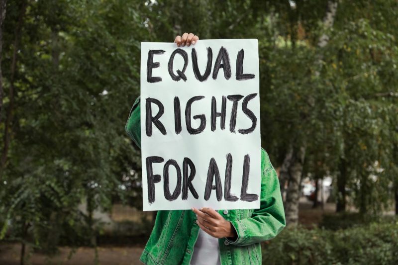 Protests Activist Holding a Placard with Equal Rights for All Text