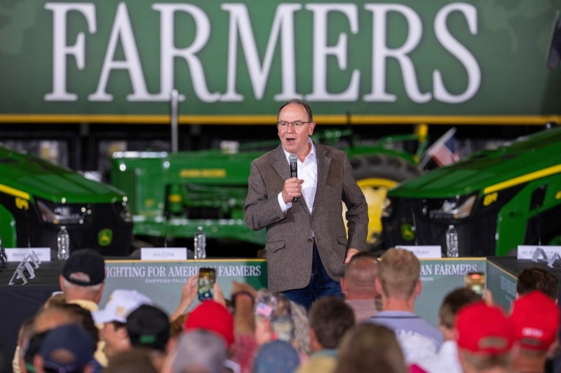 Tom Tiffany stands before a crowd at a campaign event