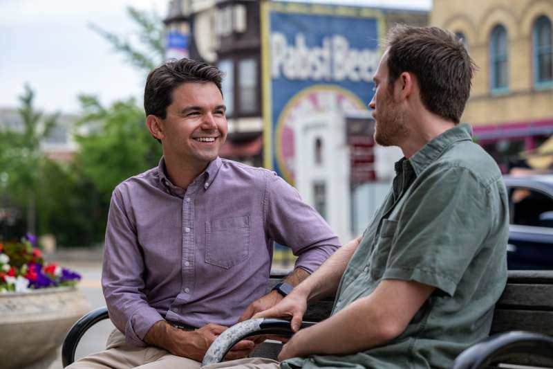 Trevor Jung speaks with a voter ahead of his state Senate run